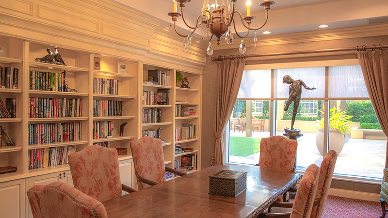 table and chairs in a study with a built-in bookcase