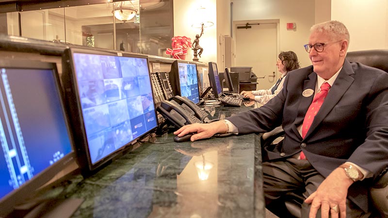 concierge sitting at his desk helping a resident